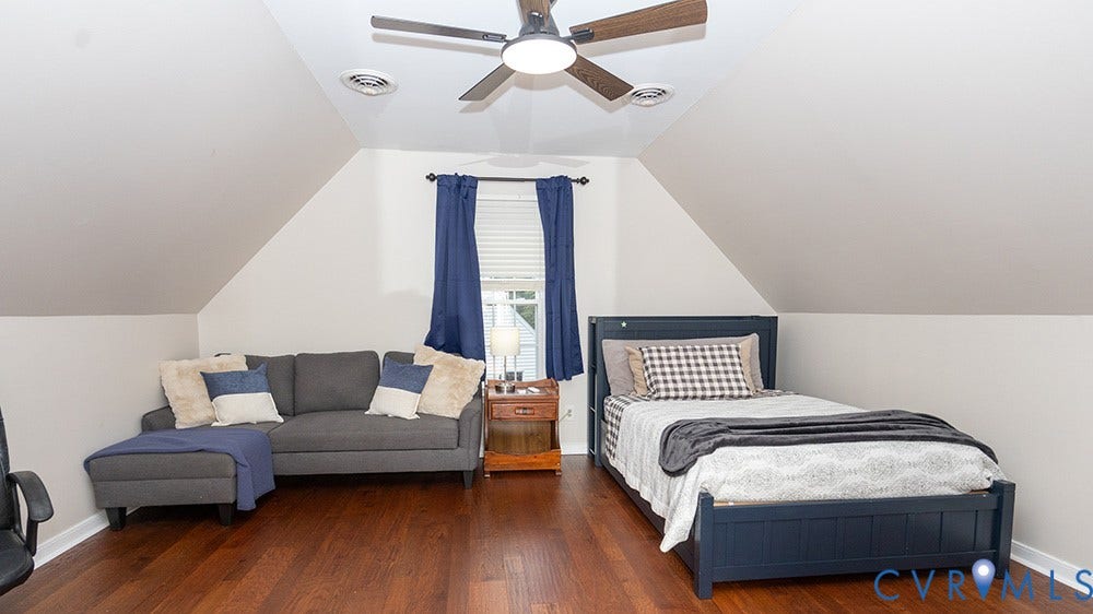 419 Rossmere Drive, Walton Park, Midlothian, VA 23114 Spacious room with sloped ceilings, rich wood-finish flooring, and a modern ceiling fan with integrated lighting