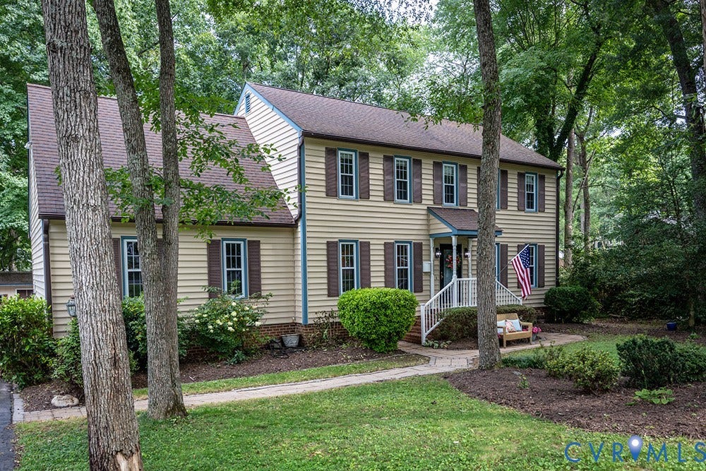 419 Rossmere Drive, Walton Park, Midlothian, VA 23114 Traditional two-story residence featuring light-colored siding, contrasting dark shutters, and a covered front porch with white railings