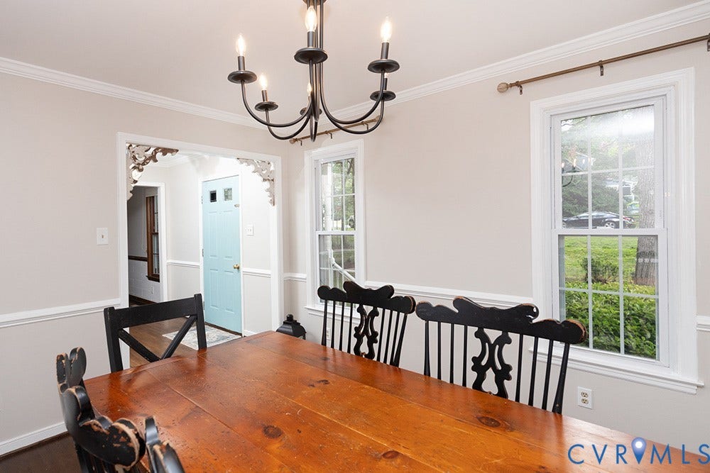 419 Rossmere Drive, Walton Park, Midlothian, VA 23114 Dining area featuring a classic black chandelier, crown molding, chair rail, and two double-hung windows