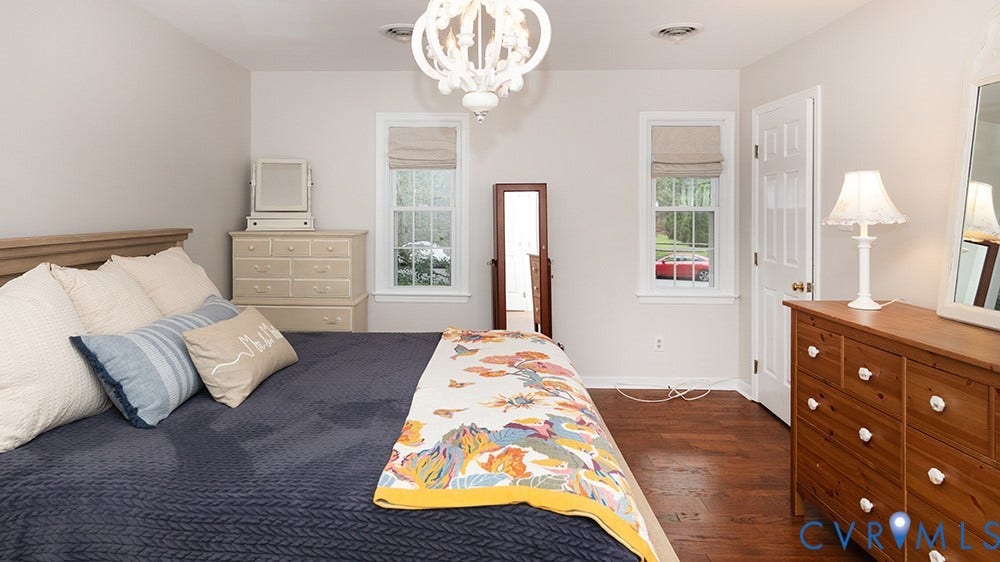419 Rossmere Drive, Walton Park, Midlothian, VA 23114 Bedroom featuring wood-finish flooring, white walls, and a decorative ceiling light fixture