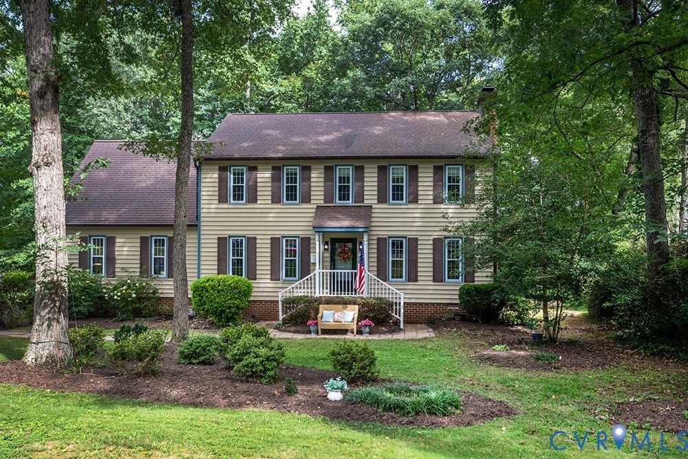 419 Rossmere Drive, Walton Park, Midlothian, VA 23114 Traditional two-story residence featuring light-colored siding, contrasting dark shutters, and a dark shingle roof