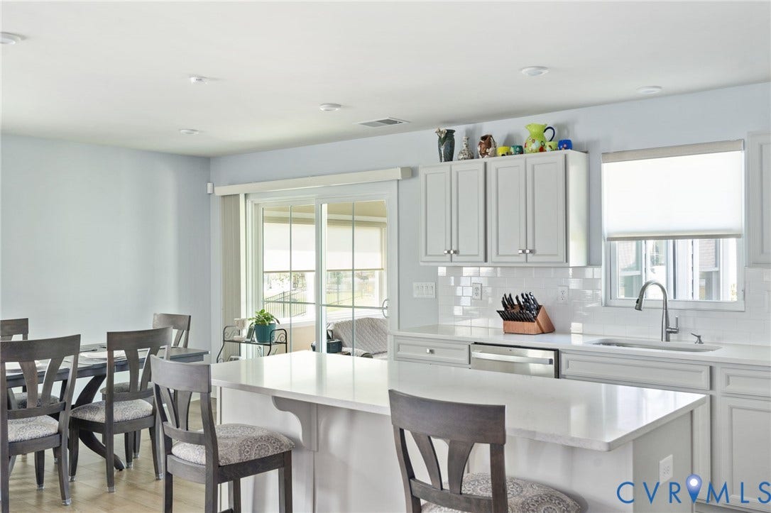7484 Southamptonshire Way, Autumn Pines, New Kent, VA 23124 Kitchen featuring light-toned cabinetry, a white subway tile backsplash, and stainless steel appliances