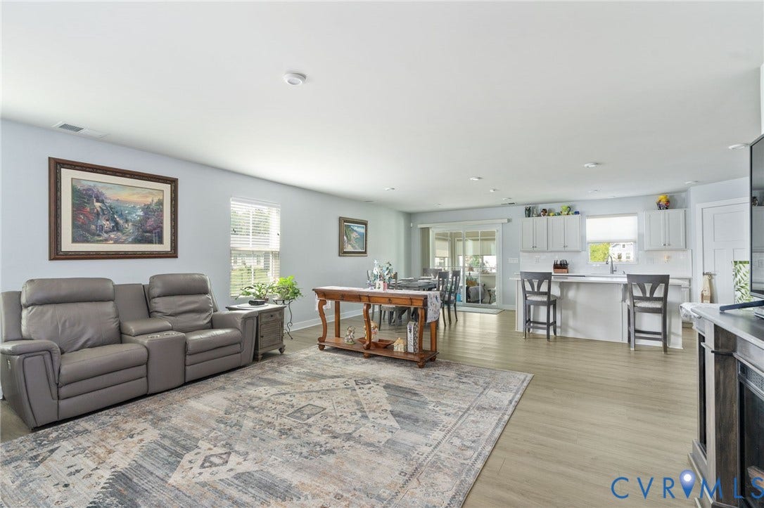 7484 Southamptonshire Way, Autumn Pines, New Kent, VA 23124 Open-concept living space featuring wood-finish flooring, recessed lighting, and light blue wall tones