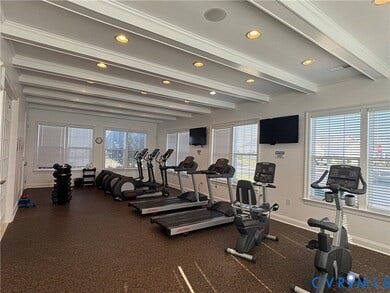 7484 Southamptonshire Way, Autumn Pines, New Kent, VA 23124 Fitness center featuring multiple exercise machines, recessed lighting, white coffered ceiling, large windows with blinds, and durable rubber flooring