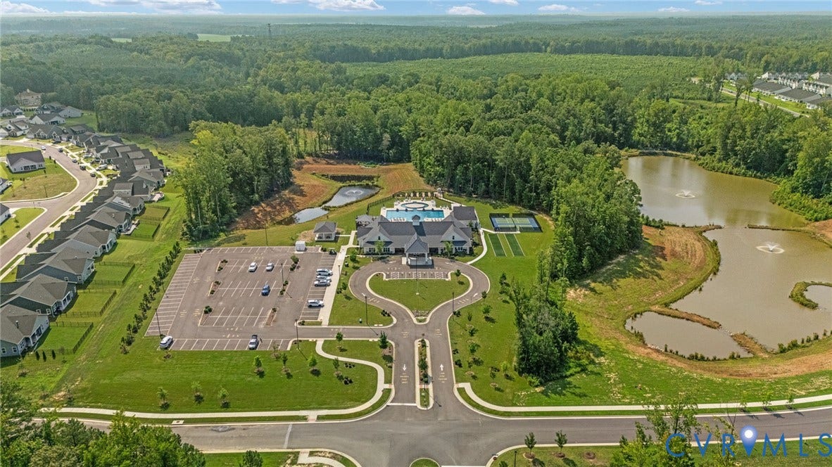 7484 Southamptonshire Way, Autumn Pines, New Kent, VA 23124 Community hub featuring a large clubhouse with a swimming pool, multiple tennis courts, and a spacious parking area
