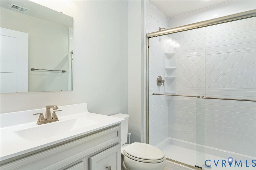 7484 Southamptonshire Way, Autumn Pines, New Kent, VA 23124 Bathroom featuring a vanity with an integrated sink, brushed nickel faucet, and coordinating mirror