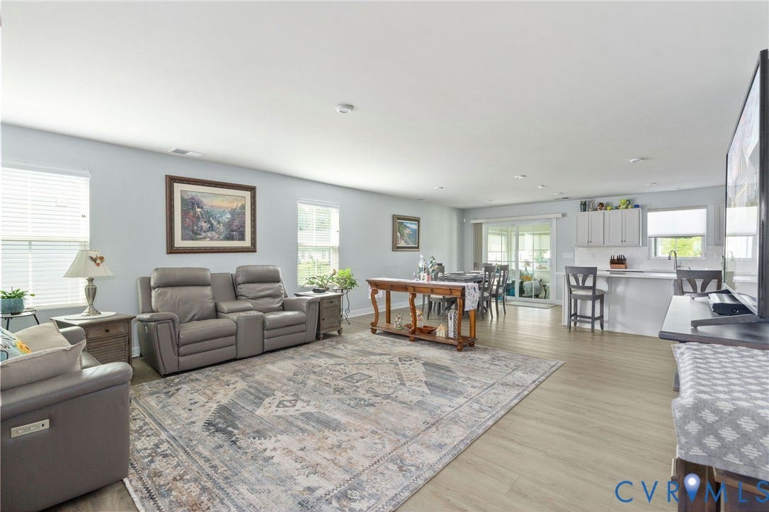 7484 Southamptonshire Way, Autumn Pines, New Kent, VA 23124 Open-concept living area featuring light wood-finish flooring throughout