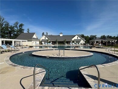 7484 Southamptonshire Way, Autumn Pines, New Kent, VA 23124 Expansive community pool featuring a curvilinear design with a central island and integrated steps
