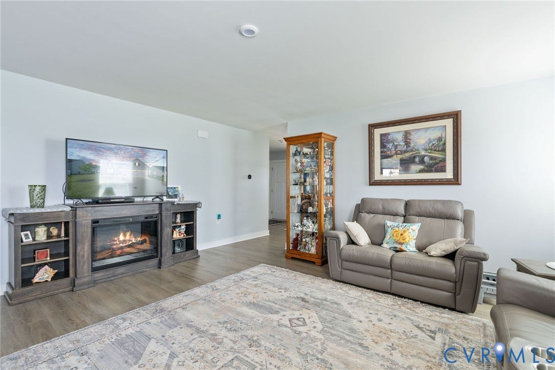 7484 Southamptonshire Way, Autumn Pines, New Kent, VA 23124 Living area featuring wood-finish flooring, a built-in electric fireplace media console with open shelving, and recessed ceiling lighting