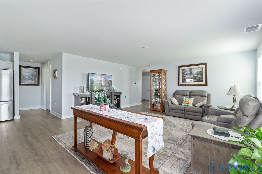 7484 Southamptonshire Way, Autumn Pines, New Kent, VA 23124 Open concept living area featuring wood-finish flooring