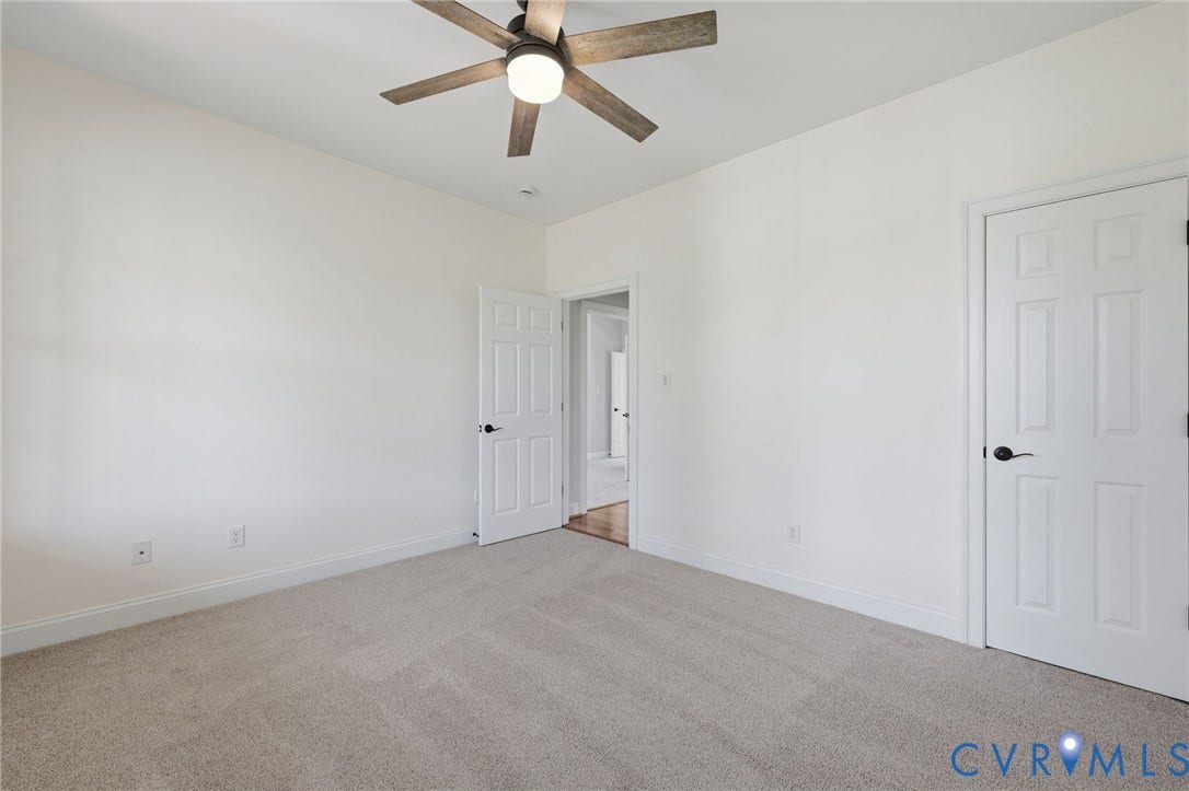 16225 Parrish Farms Road, Montpelier, VA 23192 First Floor Guest bedroom Carpeted interior room featuring a ceiling fan with integrated lighting, white walls, and white trim