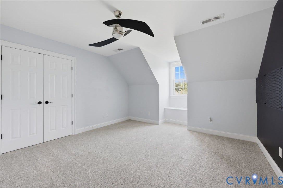 16225 Parrish Farms Road, Montpelier, VA 23192 Spacious room featuring light-toned carpet, white double-door closet, modern ceiling fan, and a built-in window bench