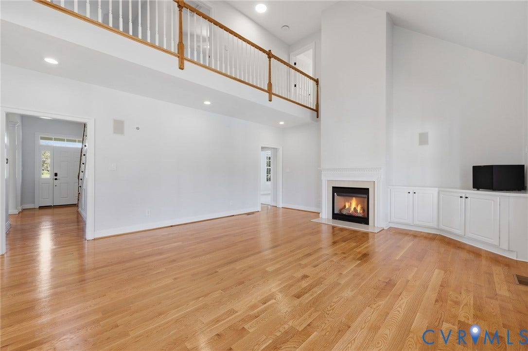 16225 Parrish Farms Road, Montpelier, VA 23192 Expansive living space featuring light wood-finish flooring and a high vaulted ceiling