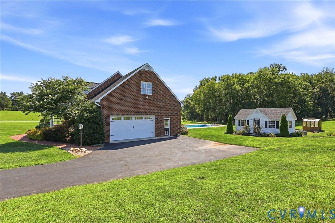 16225 Parrish Farms Road, Montpelier, VA 23192 Brick facade residence featuring an attached two-car garage, expansive green lawn, separate white outbuilding, inground swimming pool, and a dedicated greenhouse structure