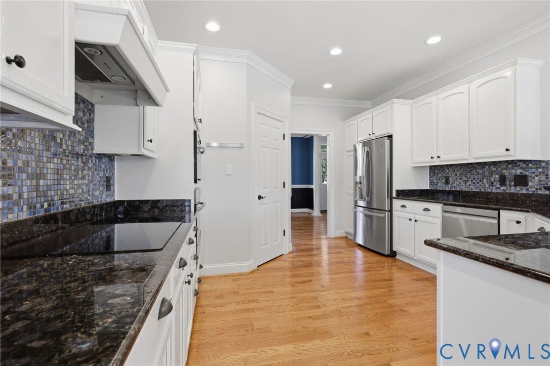 16225 Parrish Farms Road, Montpelier, VA 23192 Kitchen featuring hardwood flooring, white cabinetry, dark stone countertops, stainless steel appliances, and a mosaic tile backsplash