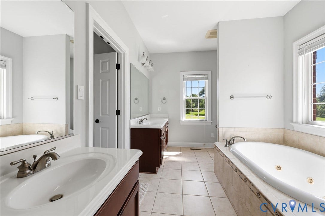 16225 Parrish Farms Road, Montpelier, VA 23192 Bathroom featuring a jetted soaking tub with tiled surround, dual vanity with undermount sinks, and tile flooring