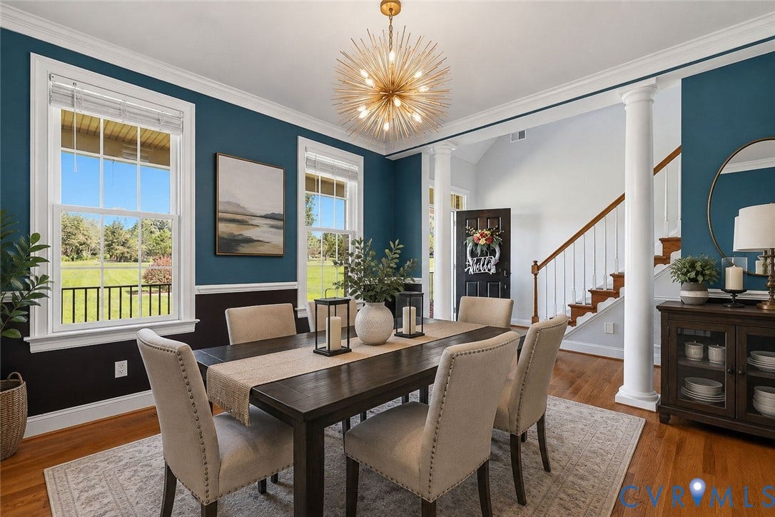 16225 Parrish Farms Road, Montpelier, VA 23192 Formal dining area featuring hardwood flooring, a contemporary sputnik chandelier, two large windows, a decorative wainscoting, and an archway with columns leading to a staircase