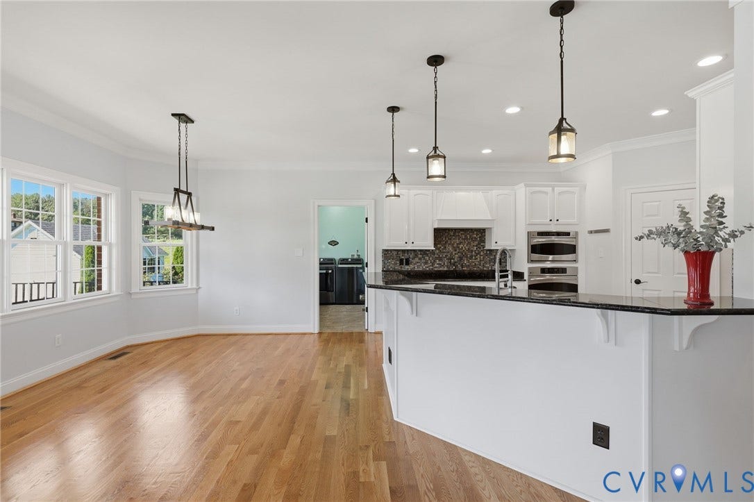16225 Parrish Farms Road, Montpelier, VA 23192 Kitchen featuring a multi-level breakfast bar with dark countertop, white cabinetry, and stainless steel built-in appliances