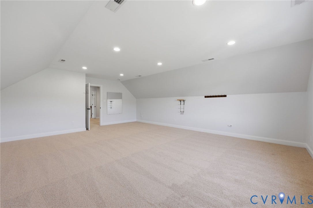 16225 Parrish Farms Road, Montpelier, VA 23192 Spacious carpeted room featuring vaulted ceilings, recessed lighting, and white baseboards