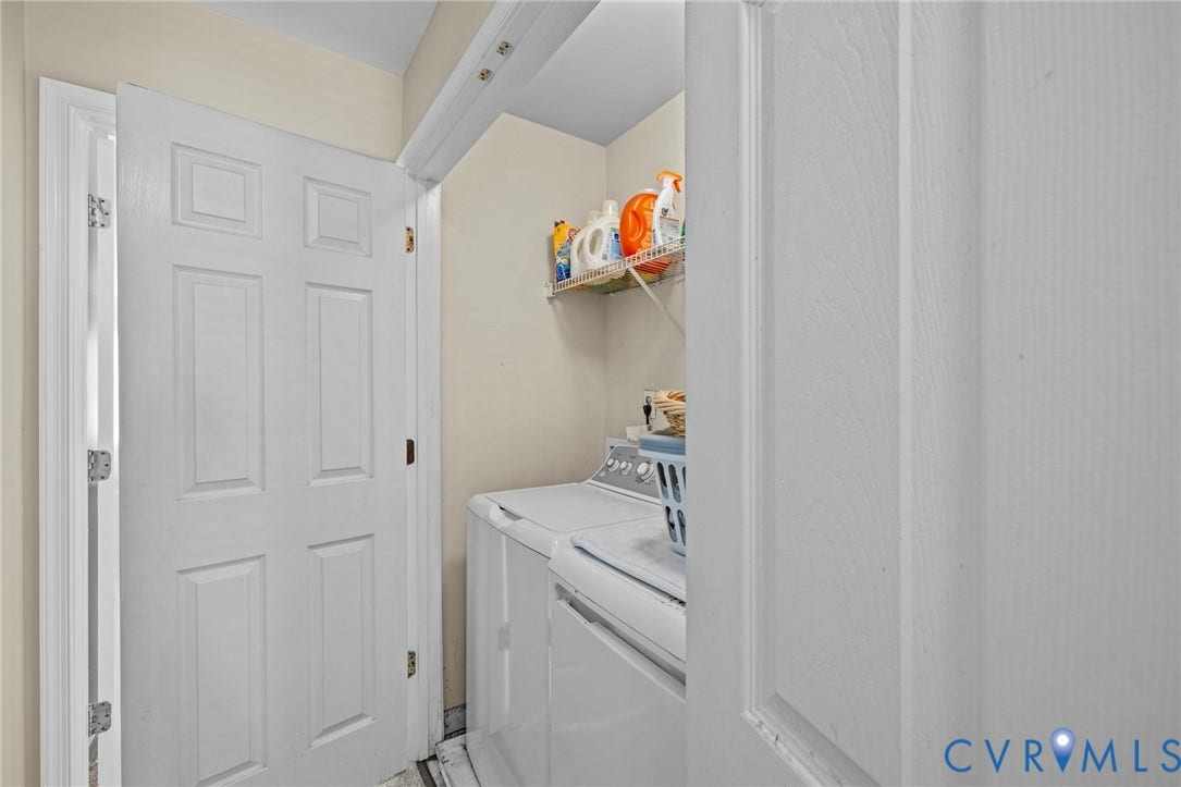 Laundry area featuring a top-load washing machine, wire shelving, and neutral wall tones
