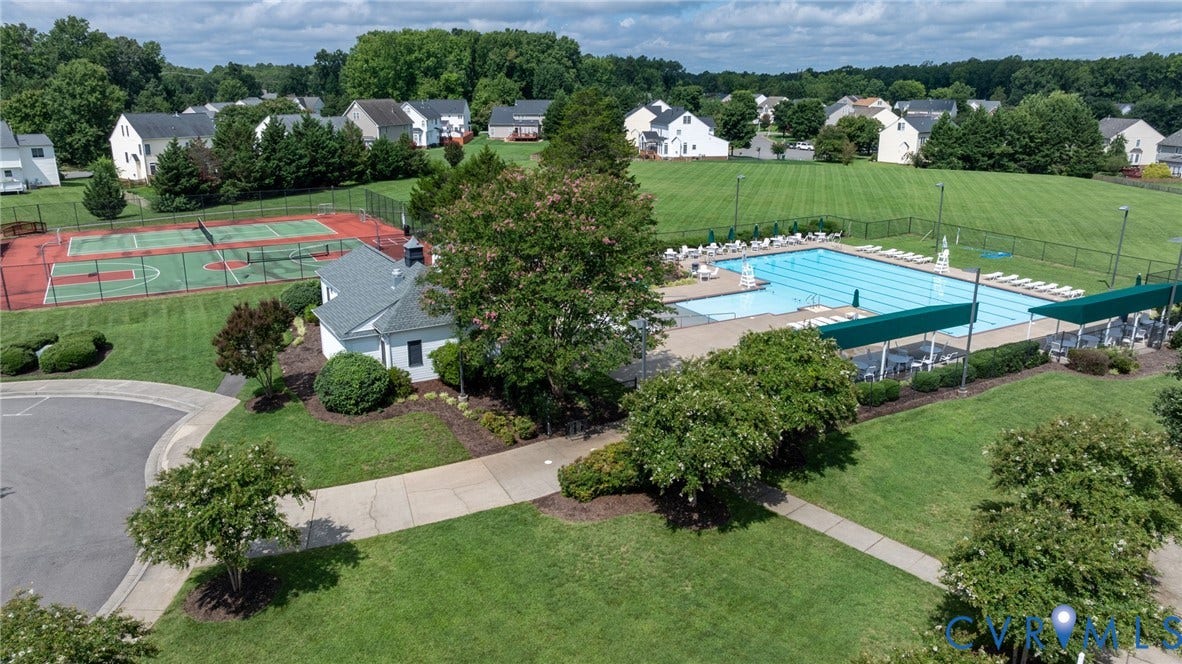Community amenities featuring a swimming pool, tennis courts, recreational building, and extensive green spaces