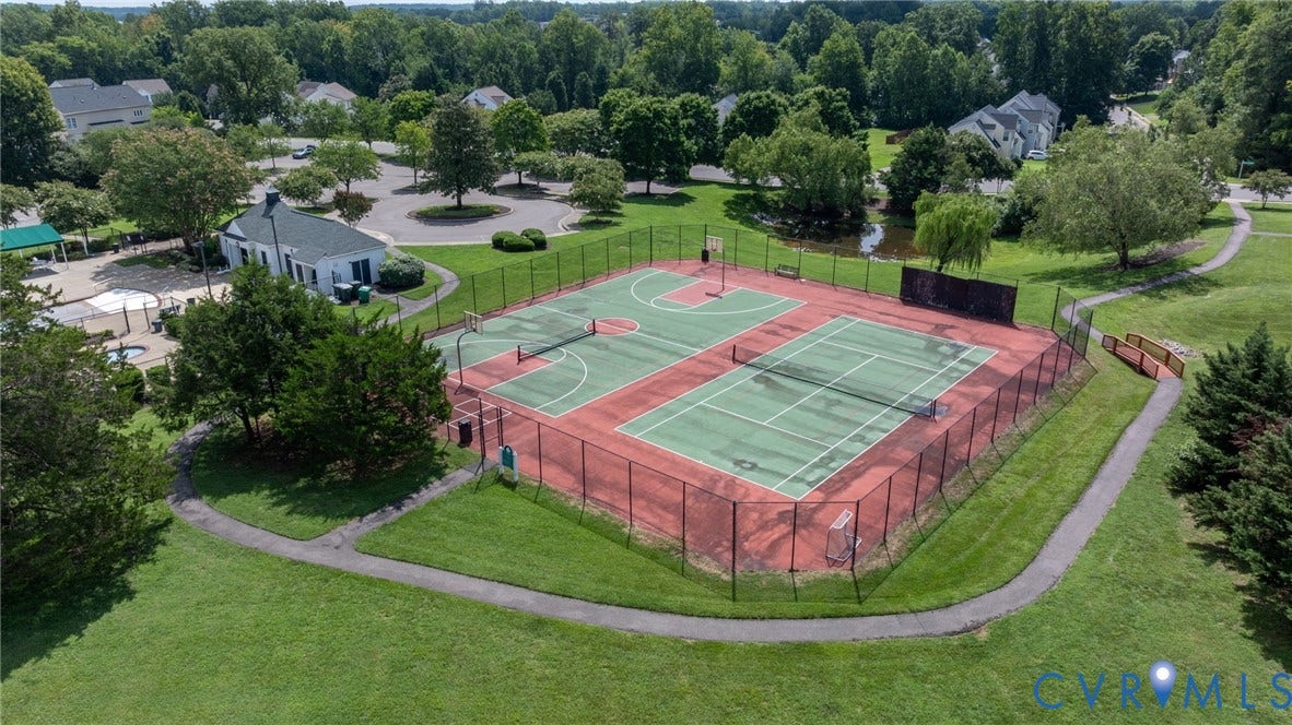 Community recreation area featuring multiple sports courts, a clubhouse, and a swimming pool complex