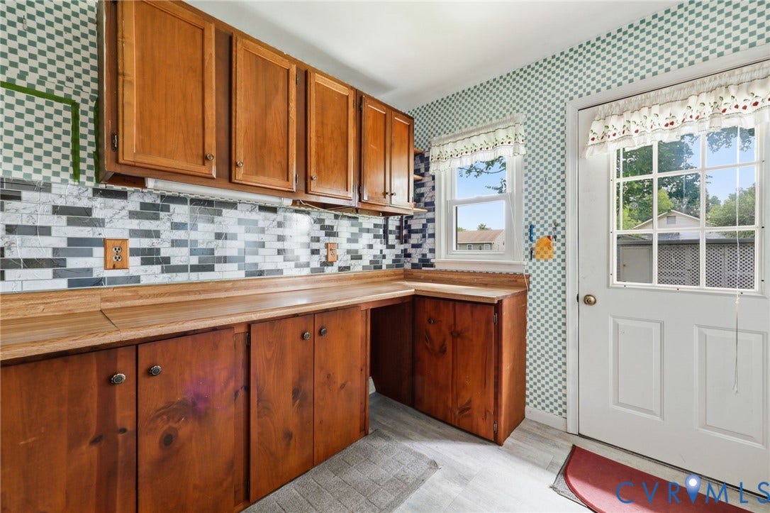 Wood-finish cabinetry paired with a mosaic tile backsplash