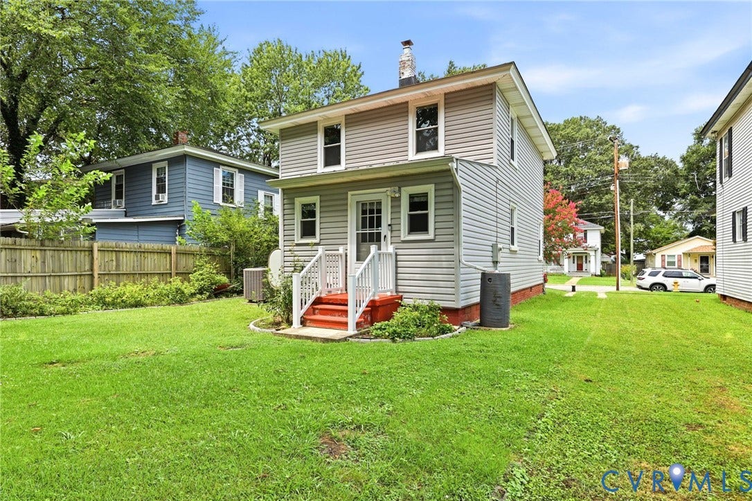 Two-story residence with light gray siding and white trim