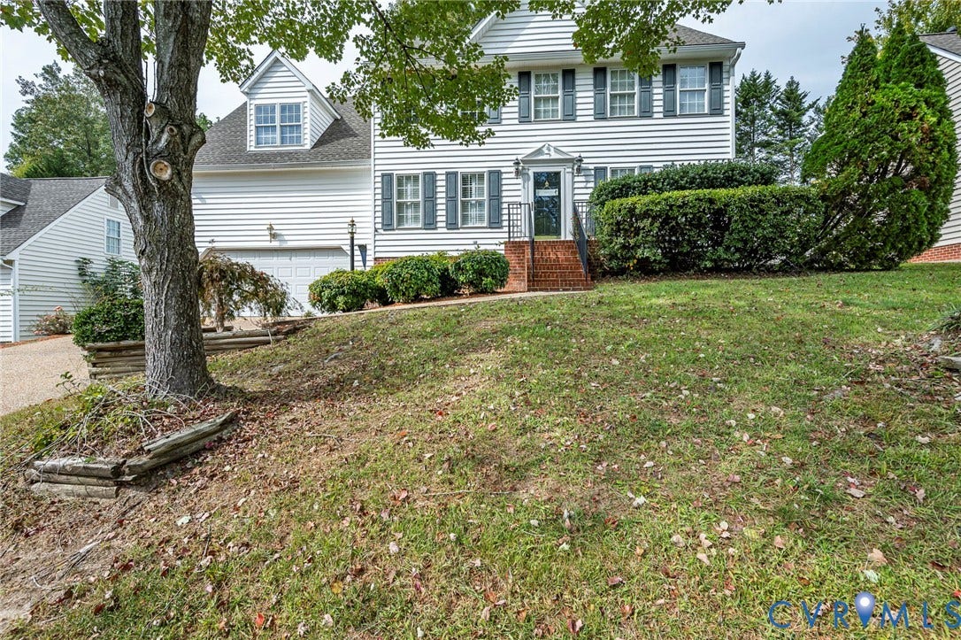 11821 Park Forest Way, Glen Allen, VA 23059 White siding residence featuring a prominent front lawn, mature tree, brick front entry stairs, a garage, and dormer windows
