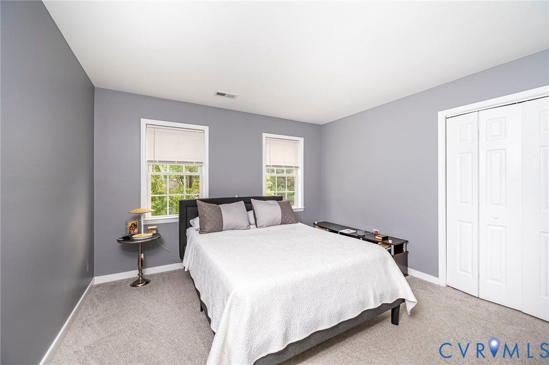 11821 Park Forest Way, Glen Allen, VA 23059 Spacious room featuring gray wall paint, white trim, two windows with window treatments, light gray carpeting, and a white bi-fold closet door
