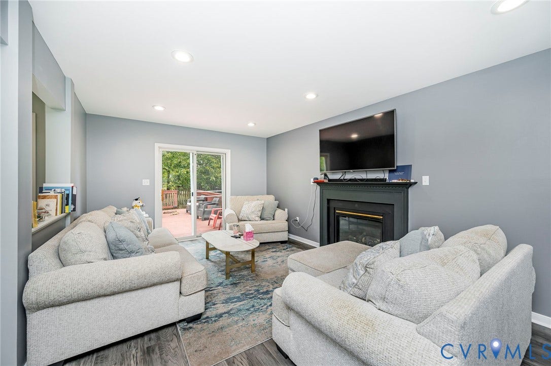 11821 Park Forest Way, Glen Allen, VA 23059 Living area featuring a fireplace with a dark mantel, recessed lighting, and wood-finish flooring