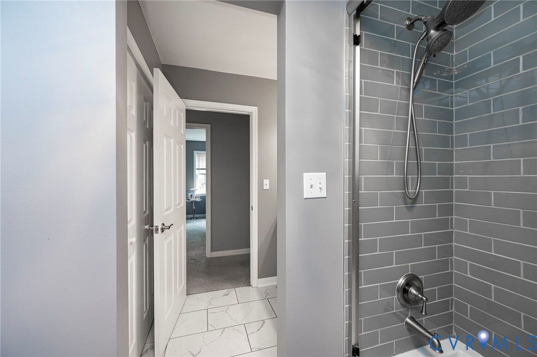 11821 Park Forest Way, Glen Allen, VA 23059 Shower featuring gray subway tile surround, brushed nickel fixtures, and a glass enclosure
