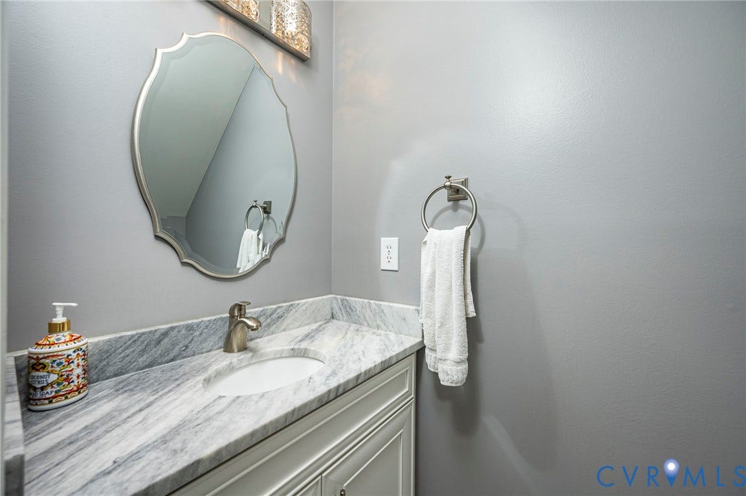 11821 Park Forest Way, Glen Allen, VA 23059 Vanity with a polished stone countertop, undermount sink, and brushed nickel faucet