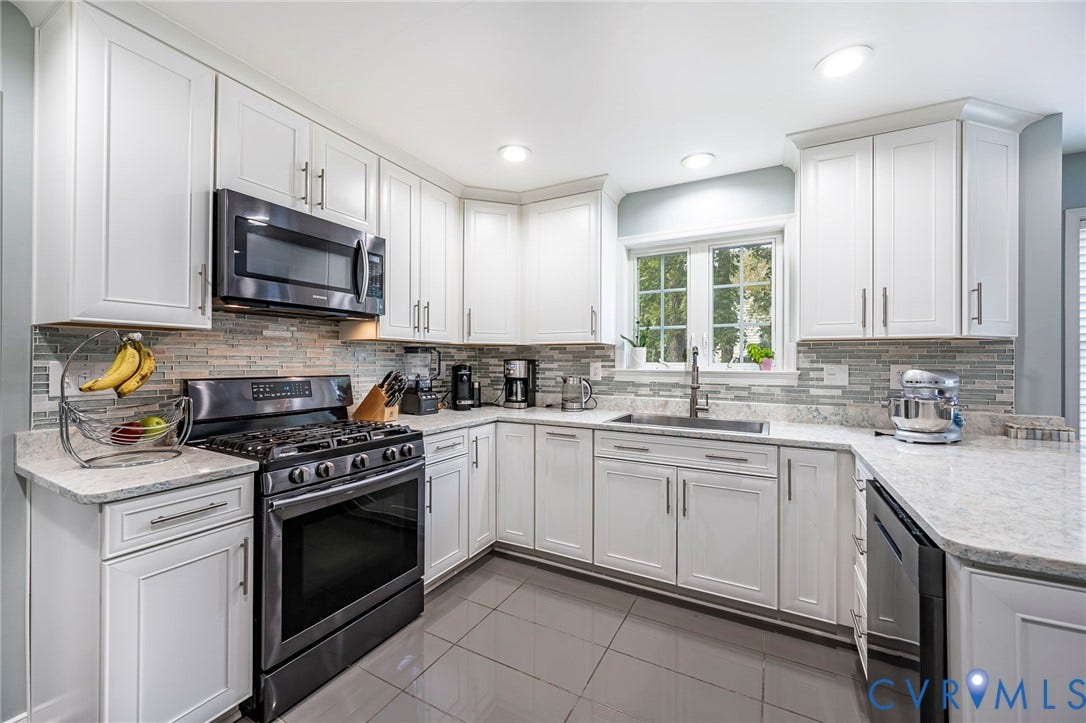 11821 Park Forest Way, Glen Allen, VA 23059 Modern kitchen featuring white cabinetry, light-toned countertops, a full suite of dark stainless steel appliances, a tiled backsplash, and recessed lighting