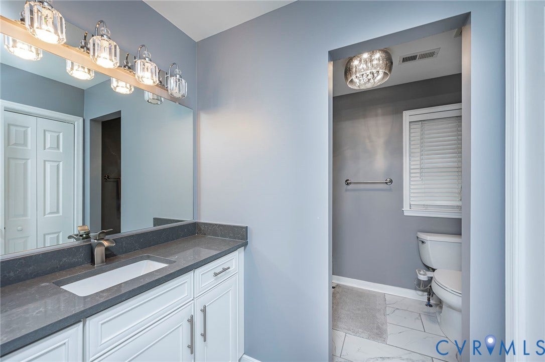 11821 Park Forest Way, Glen Allen, VA 23059 Bathroom featuring a white vanity with paneling, a dark grey stone countertop, and an undermount sink