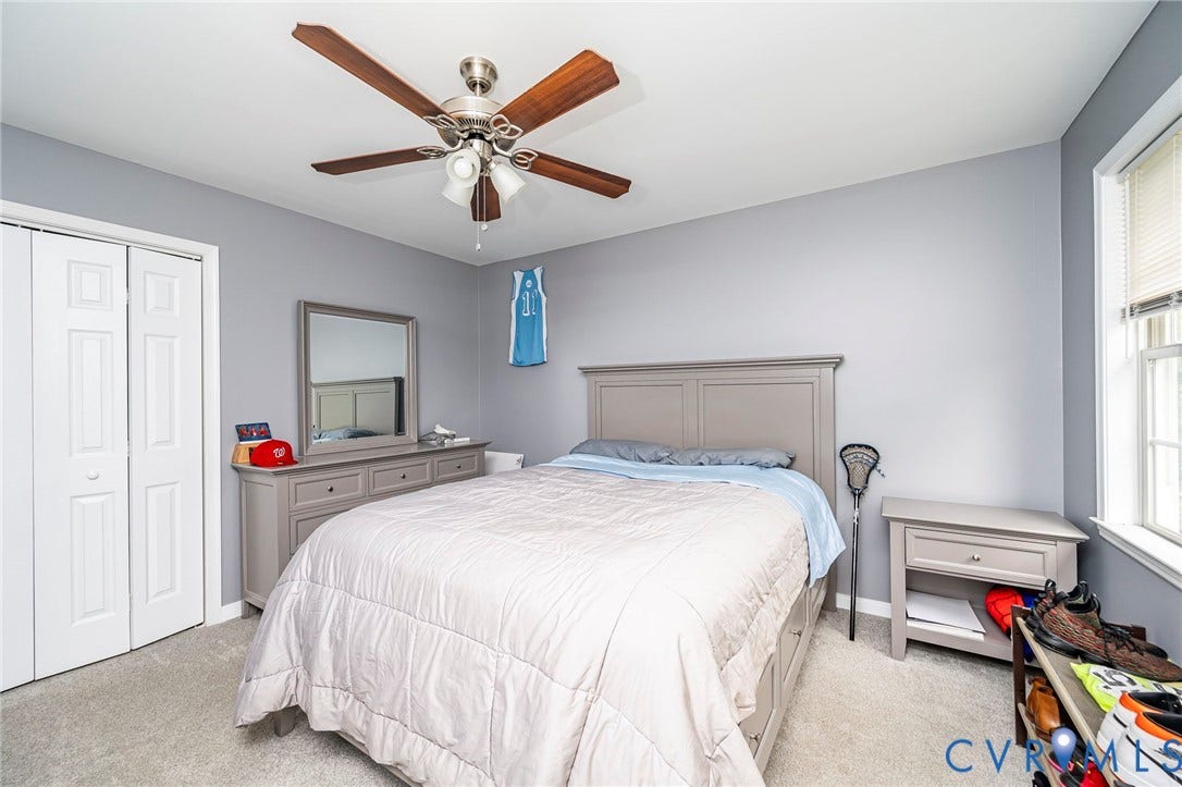 11821 Park Forest Way, Glen Allen, VA 23059 Carpeted room featuring a ceiling fan with integrated lighting, a window with blinds, and bi-fold closet doors