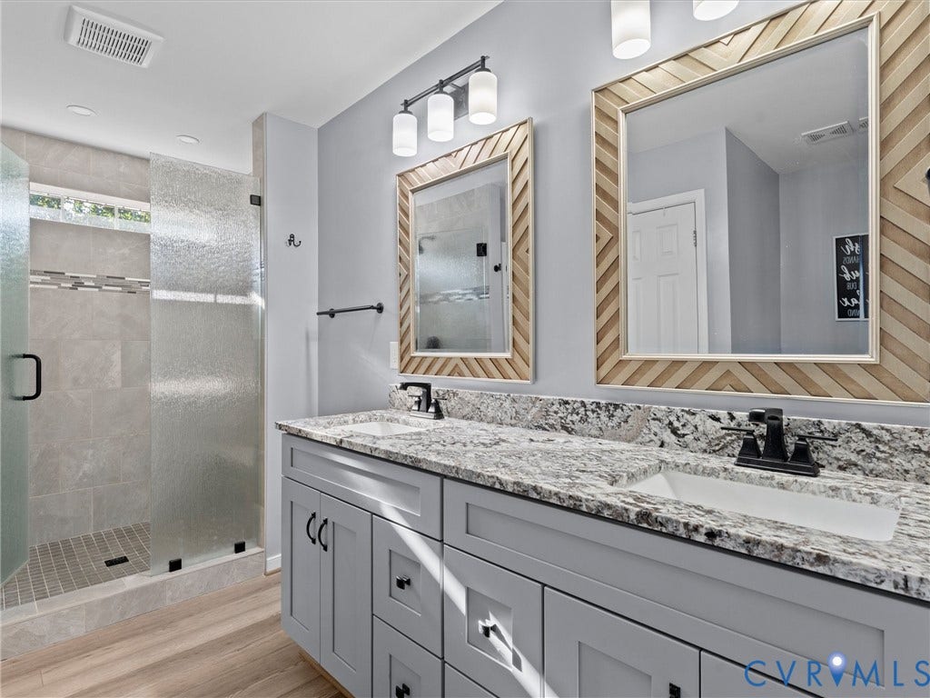 2606 Water Race Terrace, Watermill, Midlothian, VA 23112 Bathroom featuring a frameless glass shower enclosure with textured glass, light gray floor-to-ceiling tile, and a mosaic accent band