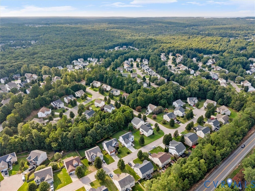 2606 Water Race Terrace, Watermill, Midlothian, VA 23112 Sprawling residential community featuring single-family homes with diverse architectural styles, surrounded by extensive mature tree lines