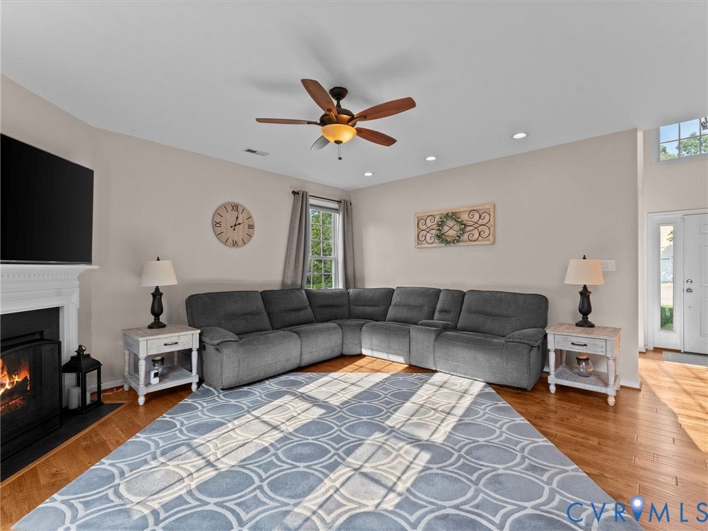 2606 Water Race Terrace, Watermill, Midlothian, VA 23112 Spacious living area featuring wood-finish flooring, a fireplace with a white mantel, and recessed lighting