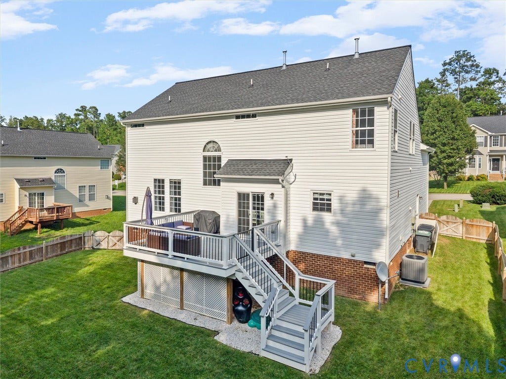 2606 Water Race Terrace, Watermill, Midlothian, VA 23112 Rear exterior featuring a white vinyl siding facade, a multi-level deck with white railings, a fenced yard, and an arched window