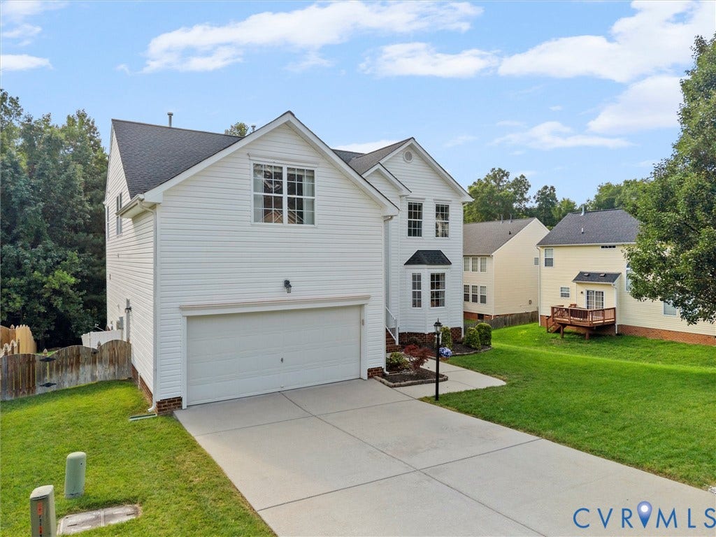 2606 Water Race Terrace, Watermill, Midlothian, VA 23112 White siding exterior with a two-car garage, concrete driveway, and front sidewalk