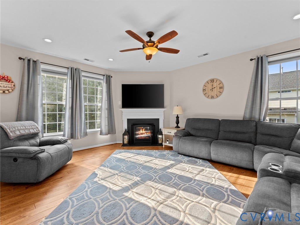 2606 Water Race Terrace, Watermill, Midlothian, VA 23112 Living area featuring wood-finish flooring, a white mantel, and a ceiling fan
