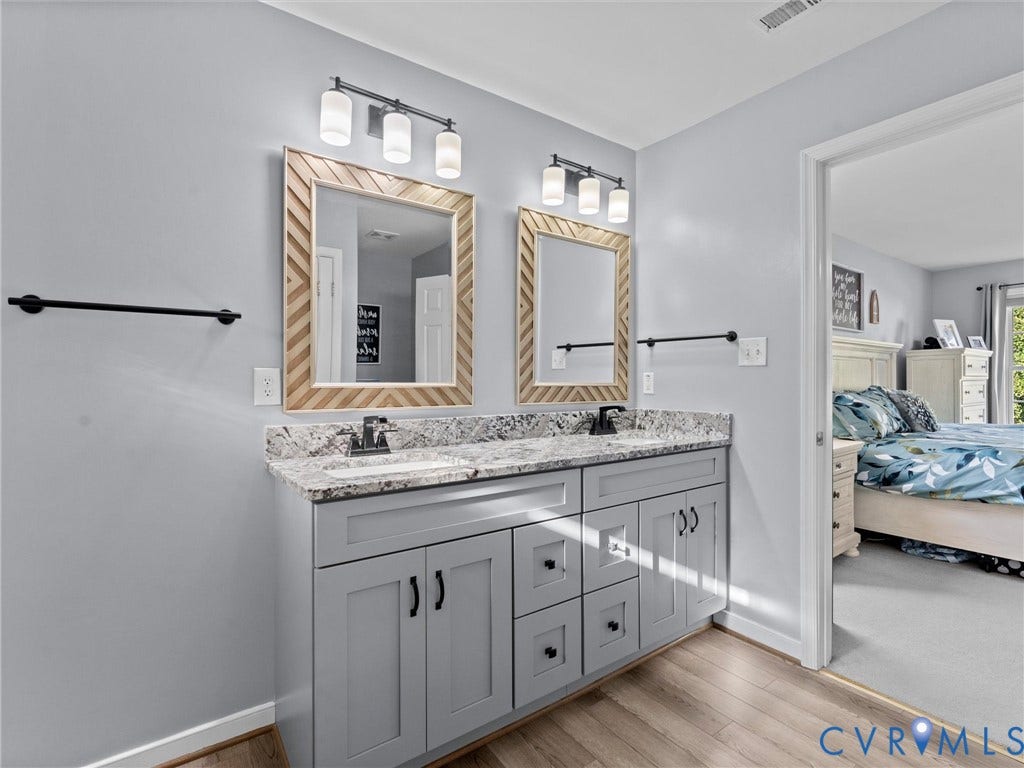 2606 Water Race Terrace, Watermill, Midlothian, VA 23112 Bathroom vanity featuring dual sinks, granite countertop, light gray cabinetry, and wood-finish flooring