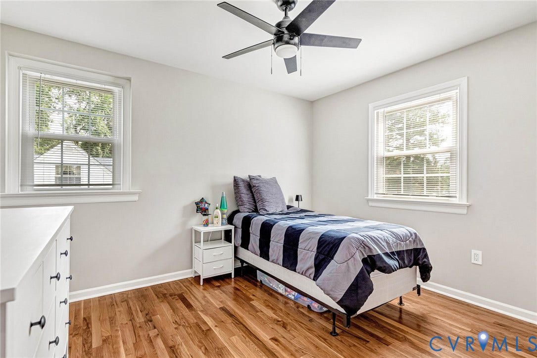 8318 Lydell Drive, Henrico, VA 23228 Hardwood flooring, two windows with blinds, ceiling fan with light, and light neutral wall colors