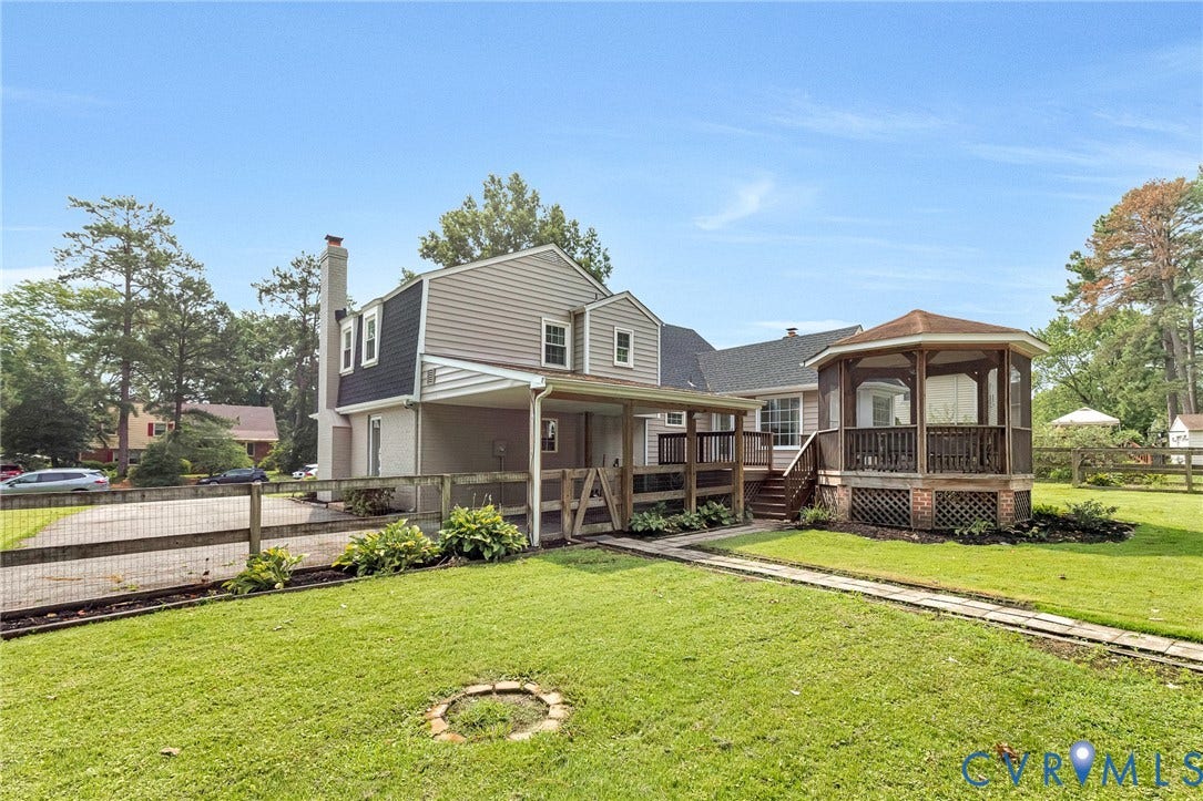 8318 Lydell Drive, Henrico, VA 23228 Expansive green lawn, elevated wooden deck, screened gazebo, wooden fence, and paved walkway