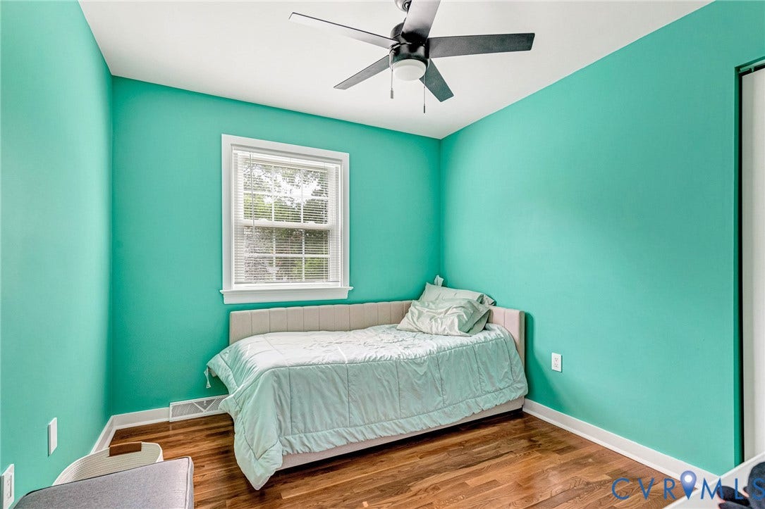 8318 Lydell Drive, Henrico, VA 23228 Recessed window with white trim, wood-finish flooring, and a ceiling fan with integrated lighting