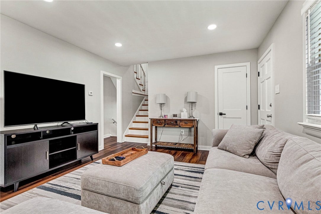 8318 Lydell Drive, Henrico, VA 23228 Recessed lighting illuminates the space, featuring wood-finish flooring and light-toned walls