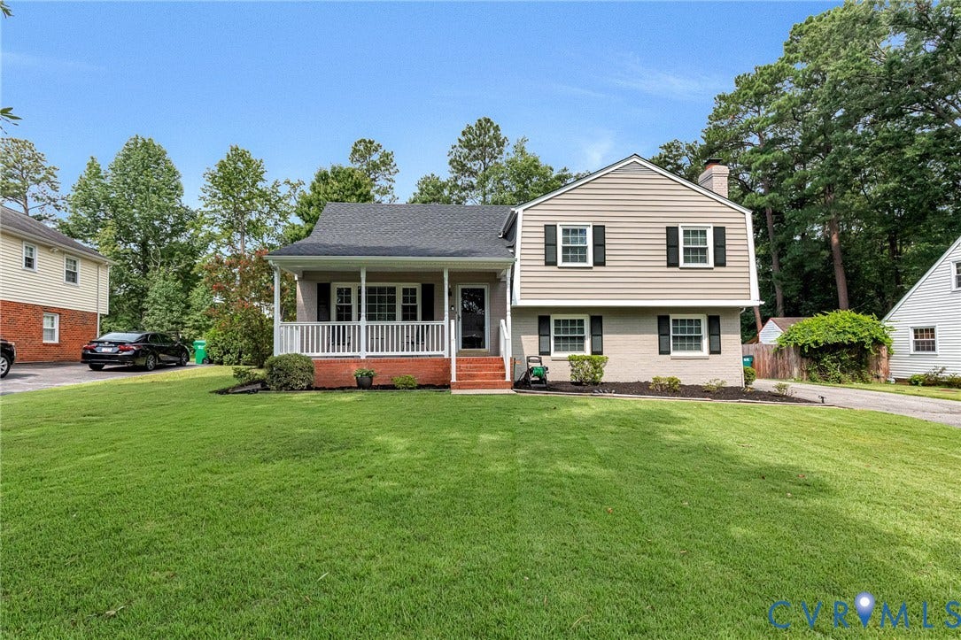 8318 Lydell Drive, Henrico, VA 23228 Split-level exterior featuring light-colored siding, brick detailing, and a covered front porch with white railings