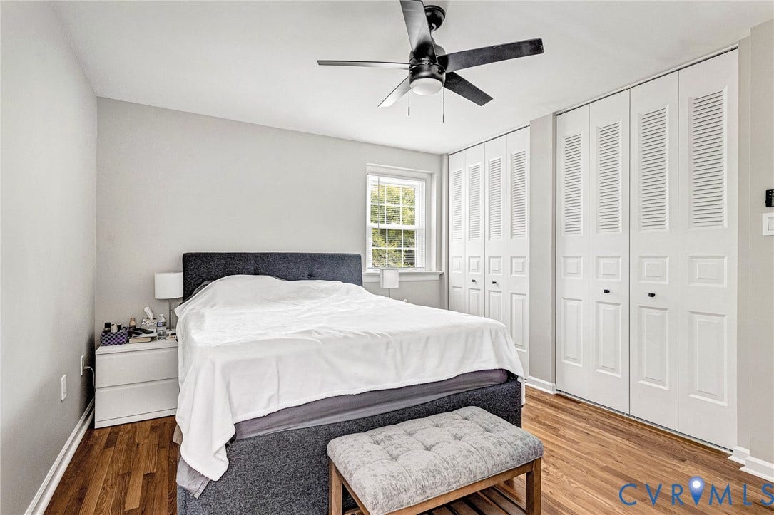 8318 Lydell Drive, Henrico, VA 23228 Wood-finish flooring, white walls, built-in bi-fold closet doors, and a ceiling fan