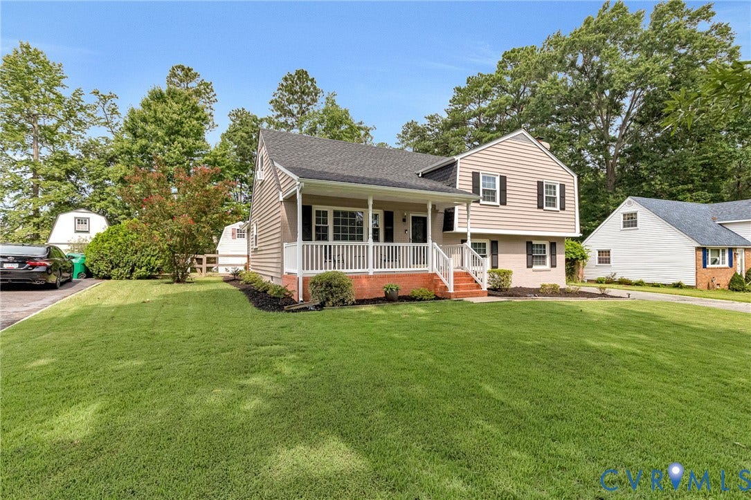 8318 Lydell Drive, Henrico, VA 23228 Split-level residence featuring a covered front porch with white railings, a dark shingle roof, and a paved driveway